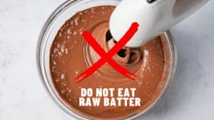 A bowl of cake batter with sign - Do Not Eat Raw Batter