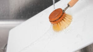 A brush washing a cutting board